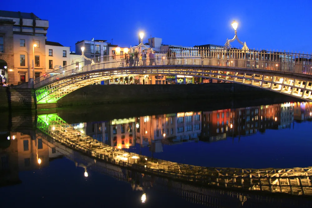 Ha'Penny Bridge in Dublin, Ireland at night.