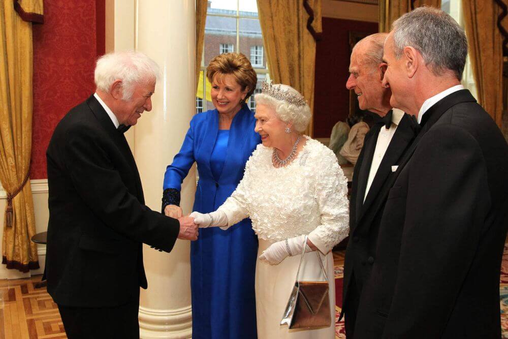 The poet Seamus Heaney (left) and the former president of Ireland Mary McAleese meet the Queen of England.