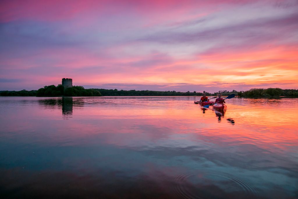 Kayaking on a like at sunset in Ireland