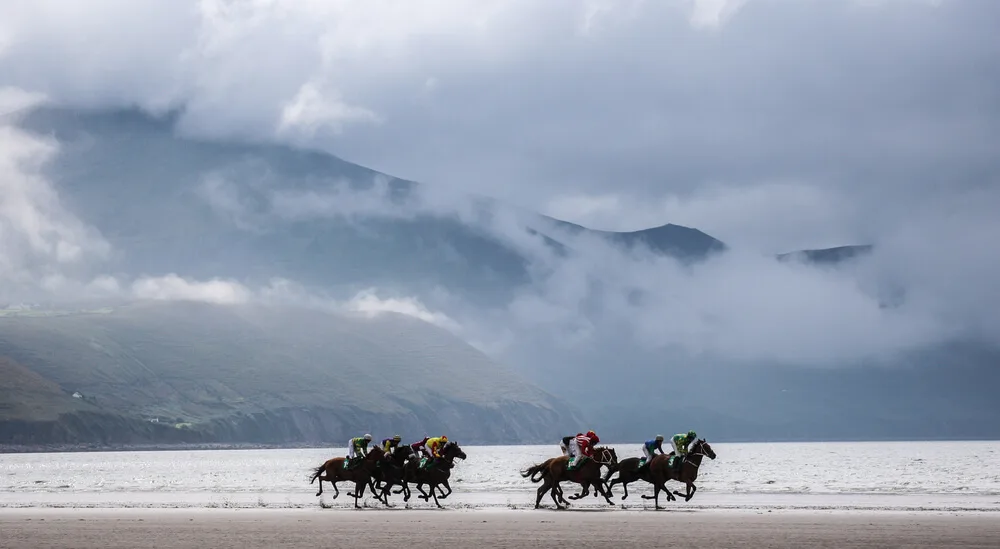 A gray day in Ireland with horse racing on the beach.
