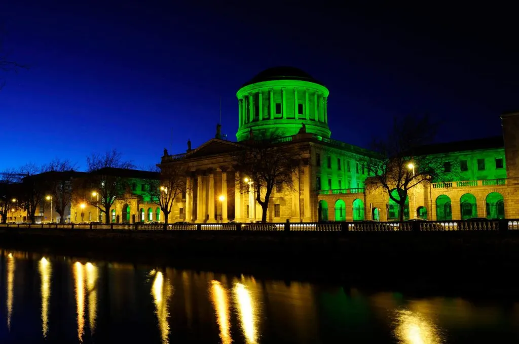The Four Courts in Dublin, Ireland illuminated in green to celebration St. Patrick's Day. 