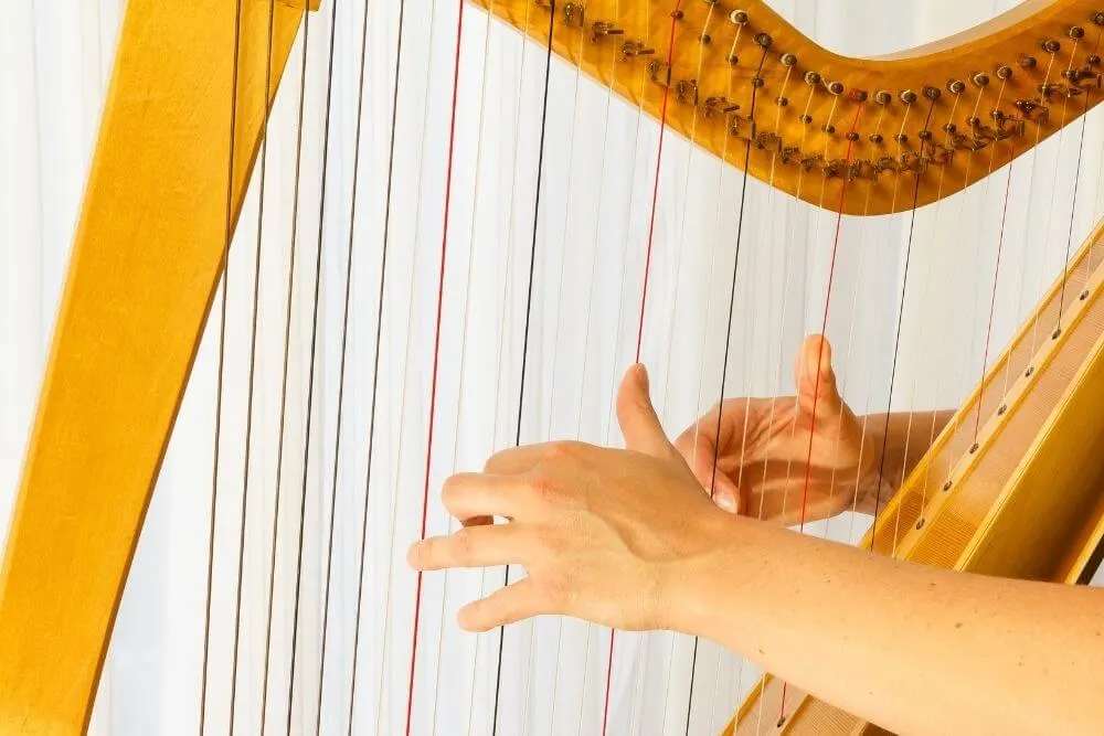 Playing a harp.