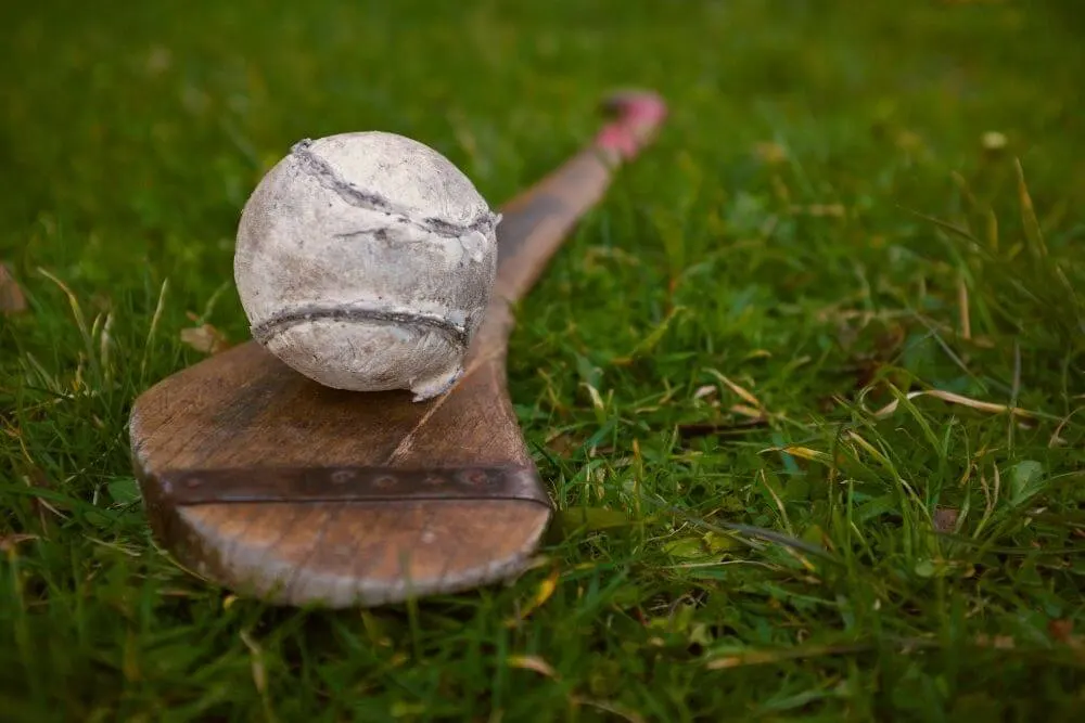 A sliotar (hurling ball) and hurley used in the traditional game of hurling.