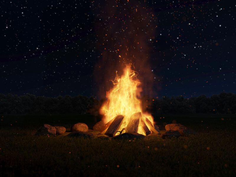 A roaring bonfire with logs on it. 