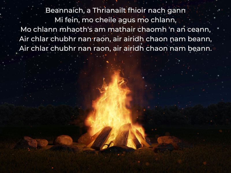 Part of Am Beannachadh Bealltain (The Beltane Blessing) over an image of a bonfire. 