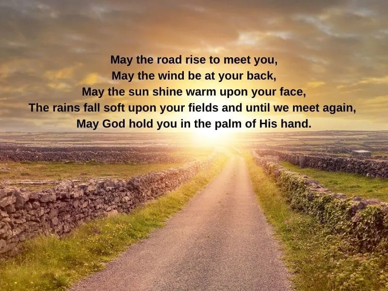 An Irish Blessing text with a road and stone walls at sunset.