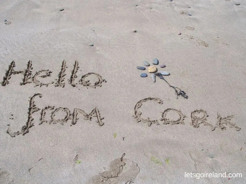 "Hello from Cork" written in sand.