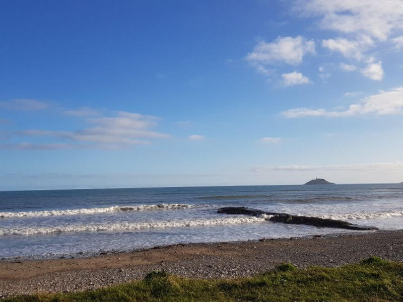 Garryvoe Beach with a view of Ballycotton lighthouse. 
