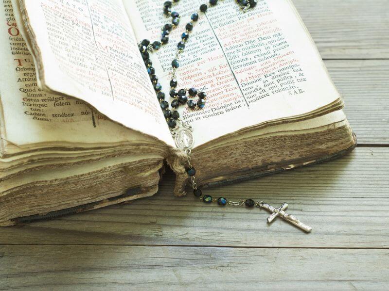 A bible and rosary beads. 